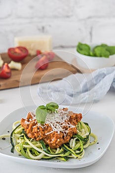 Zoodles bolognese: zucchini noodles with meat or vegan soy meat sauce and parmesan