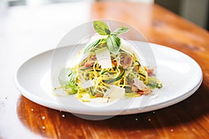 zoodles topped with parmesan and basil leaves