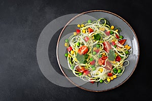 Zoodlie, healthy vegan food - zucchini noodlie with fresh green peas, tomato, bell pepper and corn for lunch