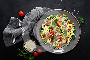 Zoodlie, healthy vegan food - zucchini noodlie with fresh green peas, tomato, bell pepper and corn for lunch