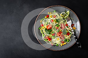 Zoodlie, healthy vegan food - zucchini noodlie with fresh green peas, tomato, bell pepper and corn for lunch