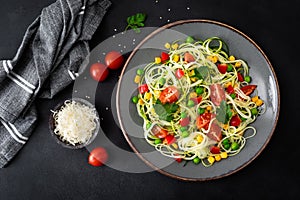 Zoodlie, healthy vegan food - zucchini noodlie with fresh green peas, tomato, bell pepper and corn for lunch