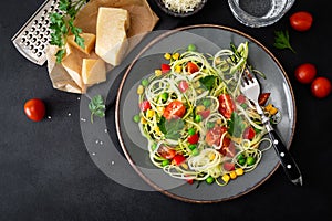 Zoodlie, healthy vegan food - zucchini noodlie with fresh green peas, tomato, bell pepper and corn for lunch