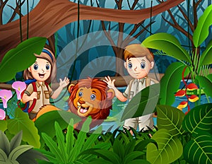 Zookeeper boy and girl with a lion in the jungle