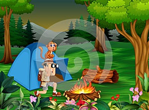 Zookeeper boy and his monkey camping in the dark forest