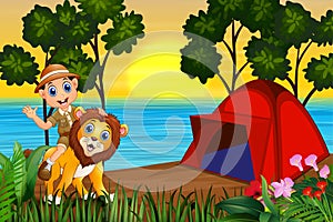 Zookeeper boy and a lion in campsite at sunset landscape