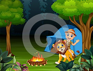 Zookeeper boy and a lion in jungle at night
