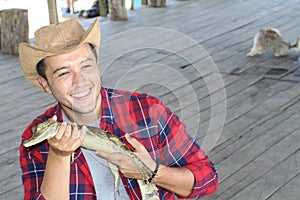 Zookeeper enjoying work with a baby caiman