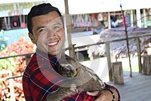 Zookeeper enjoying work with sloth bear