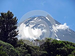 Zoom in backlighting shot of beautiful volcano summit of Mount Taranaki, New Zealand