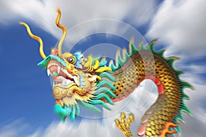 Zoom blurring china dragon statue flying in the sky.