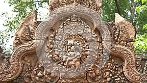 Zoom in on an intricately carved pediment at banteay srei in angkor