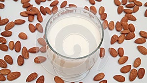 Zoom out of almond milk in a glass. Healthy non dairy milk alternative