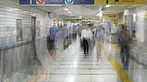 Zoom Out - Blurred Time Lapse of Commuters at Busy Tokyo Metrorail System