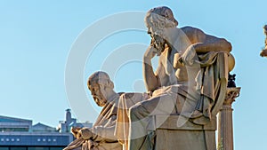 Zoom out of the statues of the Greek philosophers Socratess & Plato