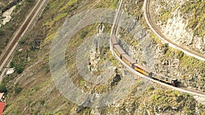 Zoom In Over Nariz Del Diablo Valley With Touristic Train In The Background