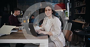 Zoom in portrait of happy positive middle aged Caucasian business woman smiling at camera working at modern loft office.