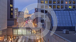 A zoom shot of public transportation down cedar street and the Minnesota State Capitol Building in Downtown St. Paul during a Glo