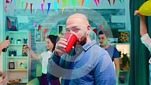 Zoom in shot of young man drinking alcohol