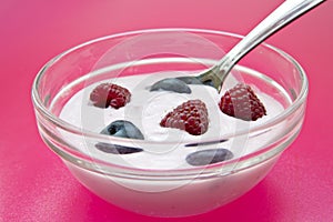 Zoomed bowl with jogurt and spoon in