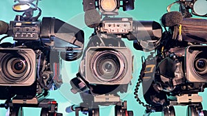 Zoomed-out image of three professional camcorders