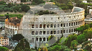Zoomed slide and pan footage of ancient Colosseum amphitheatre in evening sun. Historic tourist landmark. Rome, Italy