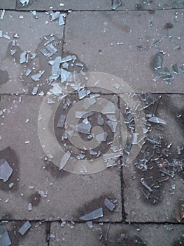 A zoomed-in view of broken glass on pavement photo