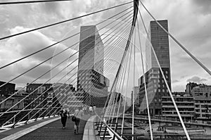 Zubizuri pedestrian bridge and Isozaki Atea skyscraper in Bilbao in black and white, Basque Country, Spain