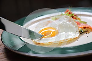 Zucchini fritters with egg on wooden table vinage style