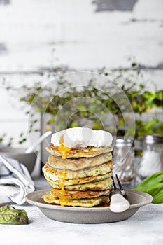 Zucchini fritters or pancakes with dill and poached egg