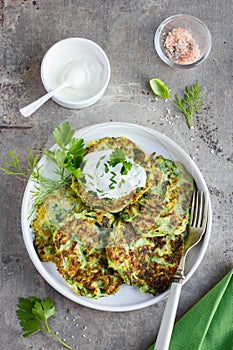 Zucchini fritters, vegetarian zucchini pancakes, served with fr