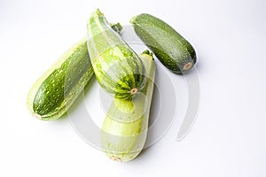 Zucchini, green summer squash on white