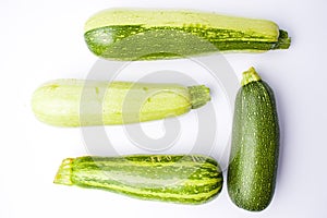 Zucchini, green summer squash on white