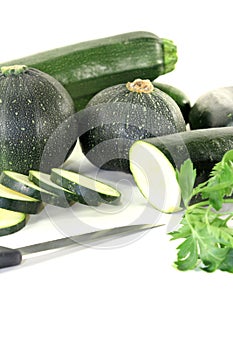 Zucchini mixed with parsley and knife