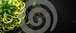 Zucchini noodles with basil on a dark background, a staple dish in cuisine