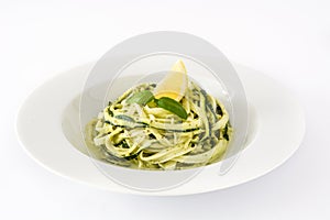 Zucchini noodles with pesto sauce on white background