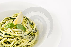 Zucchini noodles with pesto sauce on white background