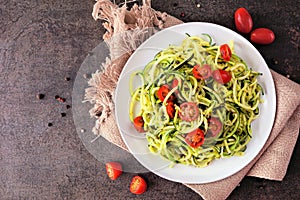 Healthy eating, low carb diet zucchini pasta. Table scene on a dark background.