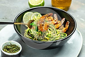 Zucchini raw pasta with pesto sauce and grilled shrimp cheese Parmesan, Restaurant menu, dieting, cookbook recipe top view