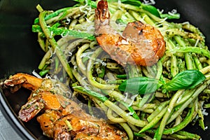 Zucchini raw pasta with pesto sauce and grilled shrimp cheese Parmesan, Restaurant menu, dieting, cookbook recipe top view