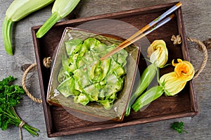 Zucchini ribbon salad with parsley, dill and garlic in marinade