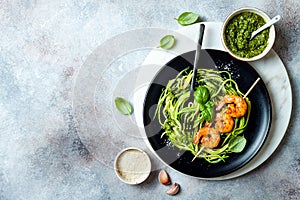 Zucchini spaghetti with pesto sauce and grilled shrimp skewers. Vegetarian vegetable low carb pasta. Zucchini noodles or zoodles.