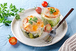 Zucchini stuffed with minced meat and rice, with tomatoes and mozzarella