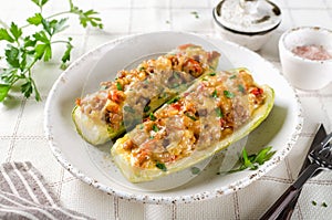 Zucchini stuffed with minced meat and tomatoes and cheese