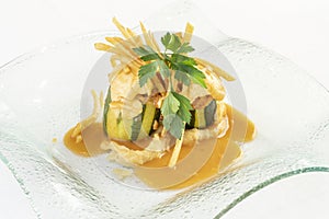 Zucchini stuffed with seafood, with baked mayonnaise and straw potato