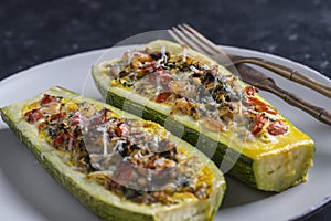 Zucchini stuffed with shrimps, vegetables and cheese. Baked zucchini boats