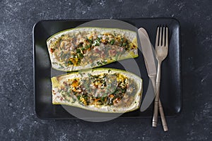 Zucchini stuffed with shrimps, vegetables and cheese. Baked zucchini boats, top view