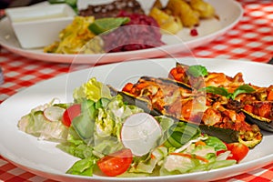 Zucchini stuffed vegetables and salad - letuce with cherry tomatoes, radish and cucumber