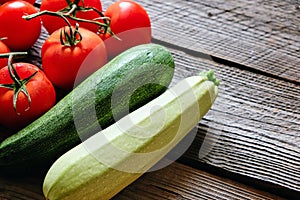 Zucchini and tomato on wood background copyspace