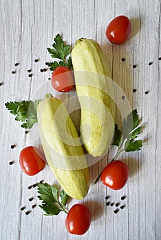 zucchini, tomatoes, parsley on a wooden background
